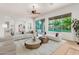 Open-concept living room featuring neutral decor, multiple seating options, and access to the outdoor space at 4494 E Reins Rd, Gilbert, AZ 85297