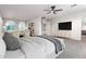 Comfortable main bedroom with neutral tones, television, king-size bed, and view to the living room at 4494 E Reins Rd, Gilbert, AZ 85297