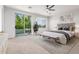 Inviting main bedroom with a balcony, a king-size bed, modern decor, and ample natural light at 4494 E Reins Rd, Gilbert, AZ 85297