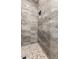 Luxurious shower featuring marble tile, built-in niche and pebble floor at 4494 E Reins Rd, Gilbert, AZ 85297