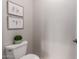 Toilet in bathroom with framed artwork and plant in pot at 4494 E Reins Rd, Gilbert, AZ 85297