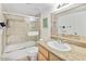 Well-maintained bathroom with a tiled shower, bathtub, and granite vanity at 4620 N 68Th St # 166, Scottsdale, AZ 85251