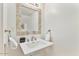 Bathroom featuring pedestal sink, decorative mirror, and elegant fixtures at 4620 N 68Th St # 166, Scottsdale, AZ 85251