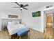 Bedroom featuring a queen bed, bright natural light, ceiling fan, television and light wood floors at 4620 N 68Th St # 166, Scottsdale, AZ 85251
