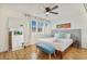 Cozy bedroom featuring a queen bed, bright natural light, ceiling fan and light wood floors at 4620 N 68Th St # 166, Scottsdale, AZ 85251