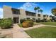 Exterior view of townhouse with well-manicured front yard and landscaping at 4620 N 68Th St # 166, Scottsdale, AZ 85251