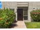 A close-up of the front door with decorative iron security door, well-maintained landscaping at 4620 N 68Th St # 166, Scottsdale, AZ 85251