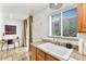 Well-lit kitchen area with granite countertops, tiled floors, and a bright window view at 4620 N 68Th St # 166, Scottsdale, AZ 85251