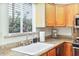 Bright kitchen featuring granite countertops, appliances, and a view of the garden at 4620 N 68Th St # 166, Scottsdale, AZ 85251