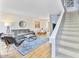 Bright living room featuring a comfortable sofa, stylish decor, and staircase to the upper level at 4620 N 68Th St # 166, Scottsdale, AZ 85251