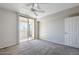 Well-lit bedroom with carpet, ceiling fan, and sliding glass door at 4925 E Desert Cove Ave # 326, Scottsdale, AZ 85254