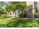 Exterior shot of building with a green lawn and mature shade trees at 4925 E Desert Cove Ave # 326, Scottsdale, AZ 85254