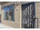Secured entrance with metal security door, exterior light, and front-facing window illuminating natural light at 4925 E Desert Cove Ave # 326, Scottsdale, AZ 85254