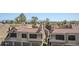 An eye-level view reveals townhome residences with red tile roofs, garages and green trees beyond at 4925 E Desert Cove Ave # 326, Scottsdale, AZ 85254