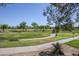 Scenic view of the community golf course with walking paths and mature trees on a sunny day at 4925 E Desert Cove Ave # 326, Scottsdale, AZ 85254