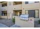 A stainless steel gas grill stands ready for use with ample counter space and adjacent greenery at 4925 E Desert Cove Ave # 326, Scottsdale, AZ 85254