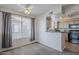 Cozy kitchen with breakfast bar, tan wooden cabinetry, and modern appliances at 4925 E Desert Cove Ave # 326, Scottsdale, AZ 85254