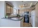 Efficient kitchen with black appliances, ample cabinet space, and tile flooring at 4925 E Desert Cove Ave # 326, Scottsdale, AZ 85254