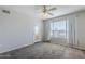 A cozy living room featuring neutral tones, a ceiling fan, and a door with natural light at 4925 E Desert Cove Ave # 326, Scottsdale, AZ 85254