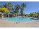 Community pool surrounded by lush landscaping, lounge chairs, and shaded seating areas at 4925 E Desert Cove Ave # 326, Scottsdale, AZ 85254