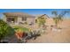 The backyard boasts a well-manicured lawn, a seating area, and beautiful desert landscaping at 5079 E Emery Rd, San Tan Valley, AZ 85143