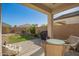 The backyard boasts a well-manicured lawn, a seating area, and beautiful desert landscaping at 5079 E Emery Rd, San Tan Valley, AZ 85143