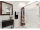 Bright bathroom with neutral paint, framed mirror, decorative towels, and a stand-up shower at 5079 E Emery Rd, San Tan Valley, AZ 85143
