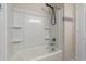 This bathroom features a shower and tub combination with built-in shelves for storage, perfect for a relaxing bathing experience at 5079 E Emery Rd, San Tan Valley, AZ 85143