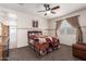 Comfortable bedroom featuring a ceiling fan and a door leading to the bathroom at 5079 E Emery Rd, San Tan Valley, AZ 85143