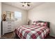Bedroom features an exterior window, neutral walls, and a wood dresser at 5079 E Emery Rd, San Tan Valley, AZ 85143