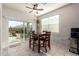 Bright breakfast nook area features a sliding glass door with outside views and a ceiling fan at 5079 E Emery Rd, San Tan Valley, AZ 85143