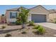 Inviting single-story home with a two-car garage, desert landscaping, and ample curb appeal at 5079 E Emery Rd, San Tan Valley, AZ 85143
