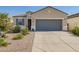 Charming single-story home featuring a neutral color scheme, desert landscaping, and a spacious two-car garage at 5079 E Emery Rd, San Tan Valley, AZ 85143