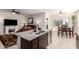 Open-concept kitchen with a view of the living room fireplace and dining area at 5079 E Emery Rd, San Tan Valley, AZ 85143