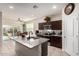 Modern kitchen featuring granite countertops, stainless steel appliances, and an open view to the dining area at 5079 E Emery Rd, San Tan Valley, AZ 85143