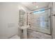 Bright bathroom features a combined tub and shower with glass door and a pedestal sink at 5812 N 18Th Pl, Phoenix, AZ 85016