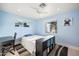 Blue bedroom with bright windows, ceiling fan, and small desk at 5812 N 18Th Pl, Phoenix, AZ 85016