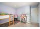 This bedroom includes a twin bunk bed, doll house, and fun decorations at 5812 N 18Th Pl, Phoenix, AZ 85016