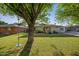 Charming home with a lush green lawn and mature tree, offering a welcoming curb appeal at 5812 N 18Th Pl, Phoenix, AZ 85016