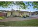 Inviting front yard with yellow Adirondack chairs on a paved patio, perfect for relaxing at 5812 N 18Th Pl, Phoenix, AZ 85016