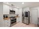 Modern kitchen with white cabinets, stainless steel appliances, and butcher block countertops at 5812 N 18Th Pl, Phoenix, AZ 85016