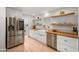 Bright kitchen featuring butcher block countertops, white cabinets, stainless steel appliances, and open shelving at 5812 N 18Th Pl, Phoenix, AZ 85016