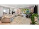 Spacious living room with a comfortable sectional, brick accent wall, and stylish decor at 5812 N 18Th Pl, Phoenix, AZ 85016
