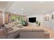 Bright living room with exposed brick, a plush sectional, and natural light at 5812 N 18Th Pl, Phoenix, AZ 85016
