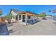 View of a charming single-story home featuring a covered patio and low-maintenance landscaping in the backyard at 6623 N 85Th Ave, Glendale, AZ 85305