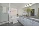 Bathroom featuring a soaking tub, walk-in shower, and double sink vanity at 6623 N 85Th Ave, Glendale, AZ 85305