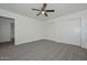 Spacious bedroom features neutral carpet, a ceiling fan, and double-door closet at 6623 N 85Th Ave, Glendale, AZ 85305