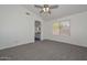 Spacious bedroom with a fan providing a comfortable atmosphere and convenient access to other areas of the home at 6623 N 85Th Ave, Glendale, AZ 85305