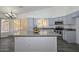 Updated kitchen with granite countertops, stainless steel appliances, and large island at 6623 N 85Th Ave, Glendale, AZ 85305