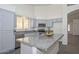 A well-lit kitchen with granite countertops, modern appliances, and light blue cabinets at 6623 N 85Th Ave, Glendale, AZ 85305
